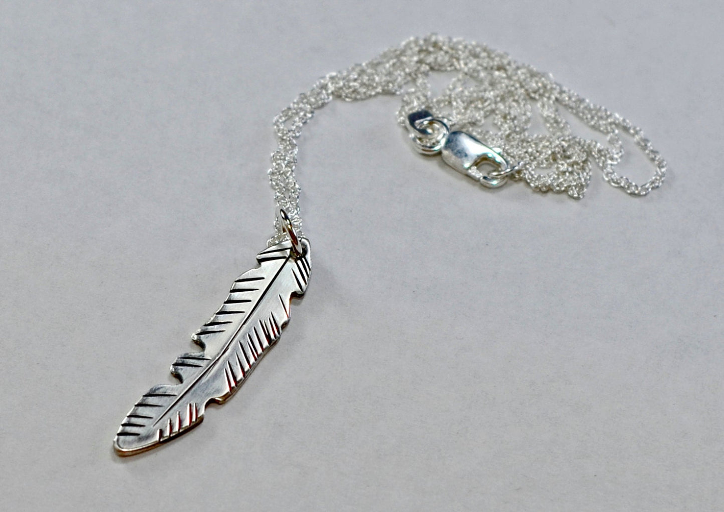 Dainty small sterling silver feather necklace