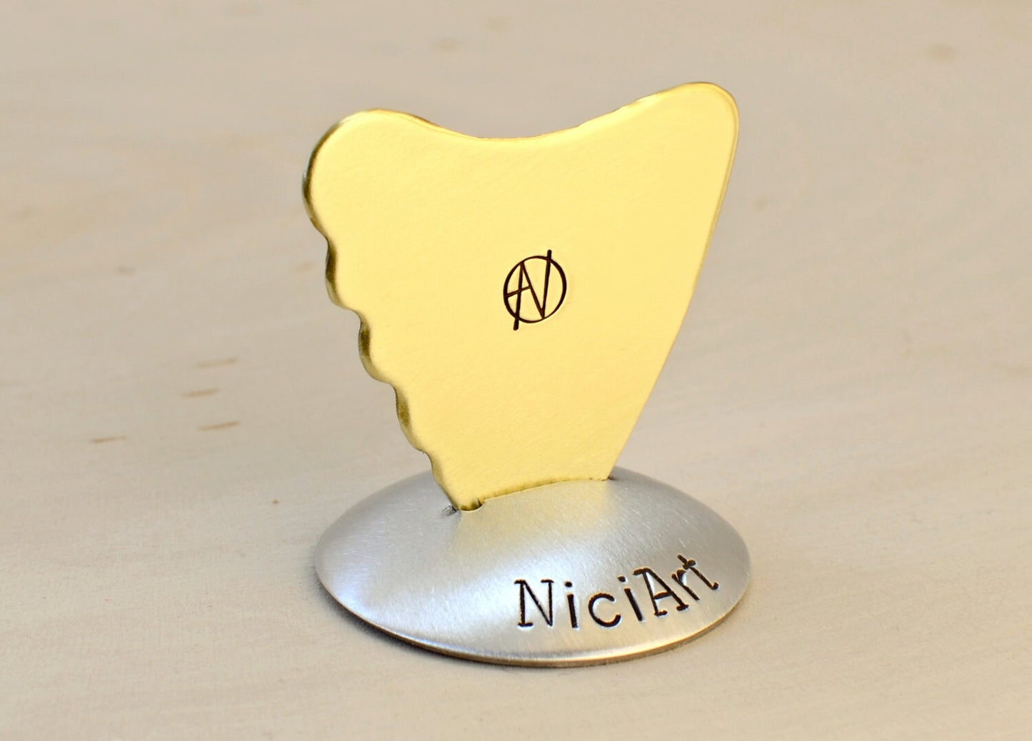 Shark Fin Brass Guitar Pick with a simple guitar theme