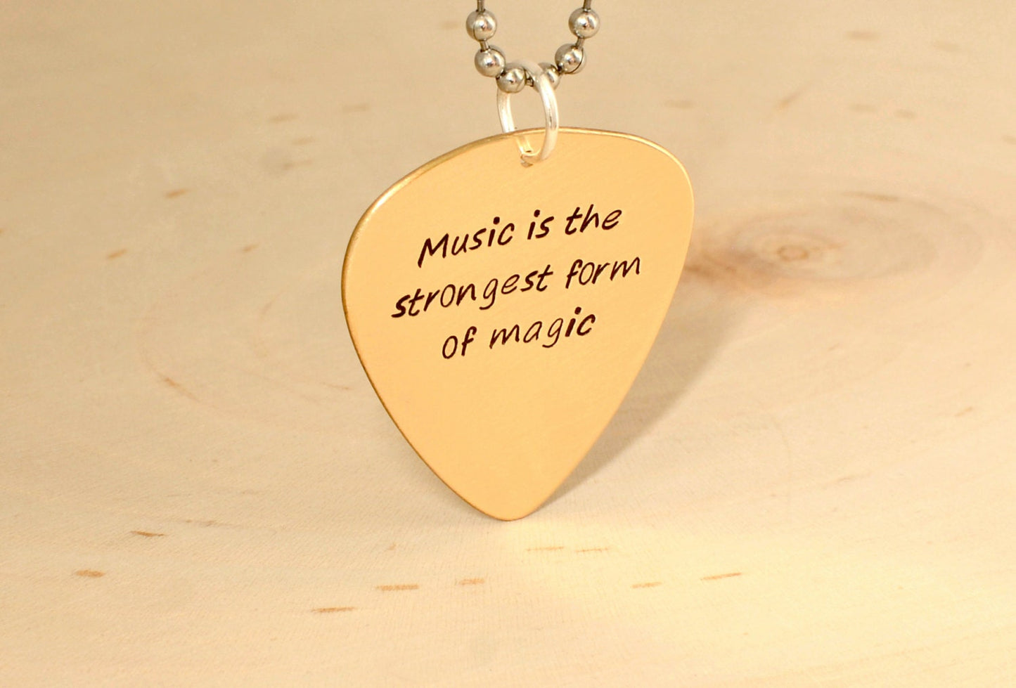 Bronze guitar pick necklace to engrave