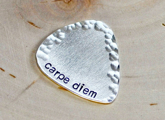 playable sterling silver guitar pick with carpe diem and a hammered border