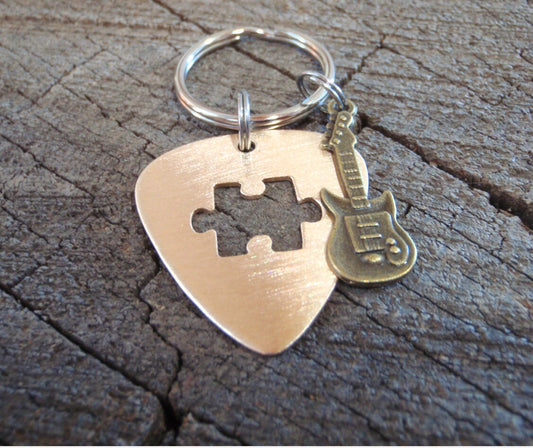 Guitar pick key ring with cutout puzzle piece in bronze and brass guitar charm