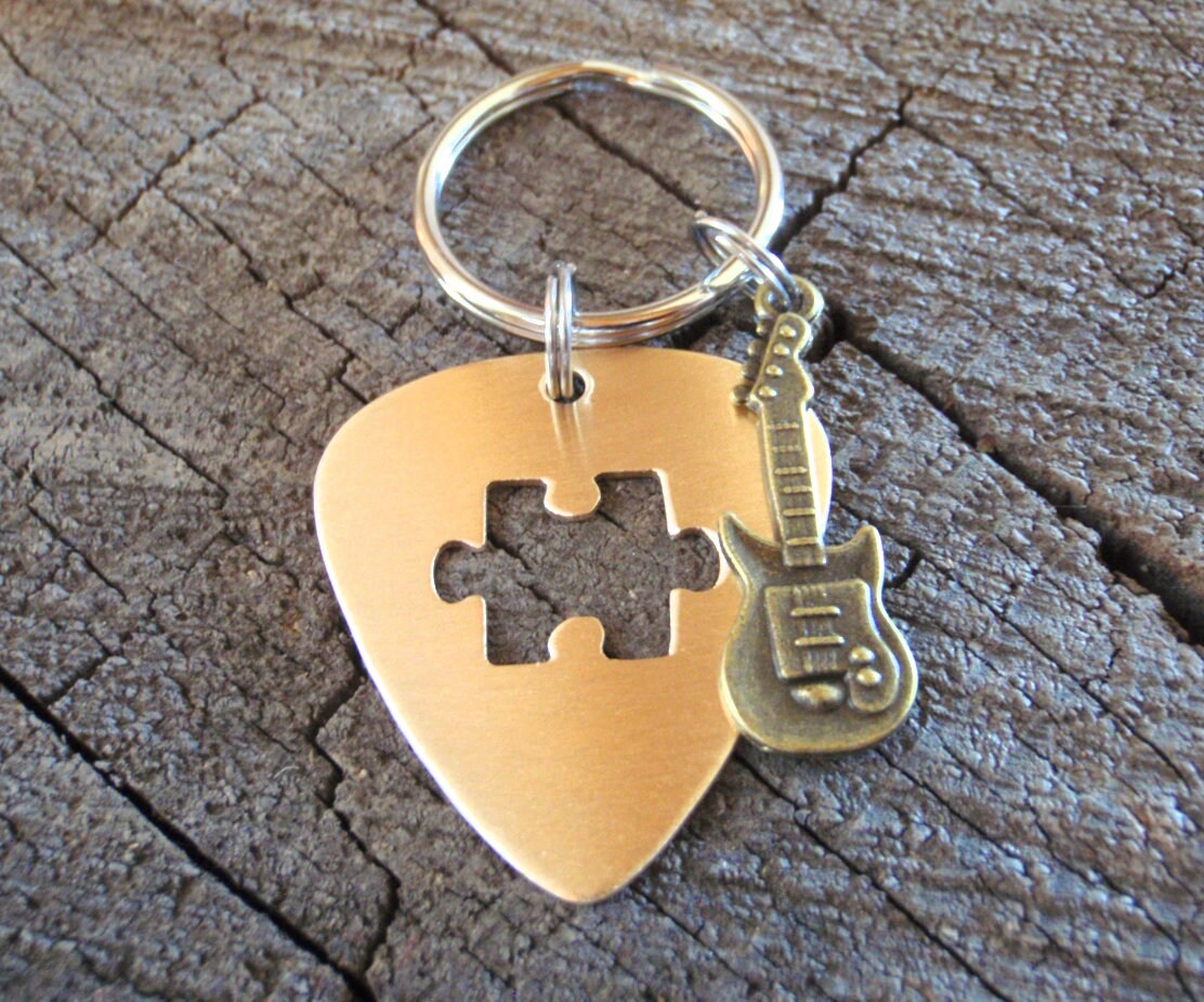 Guitar pick key ring with cutout puzzle piece in bronze and brass guitar charm