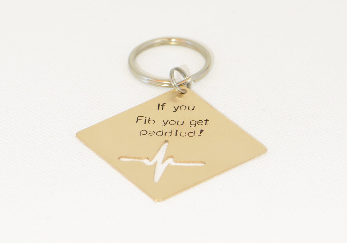 If you Fib you get paddled bronze key chain with heartbeat