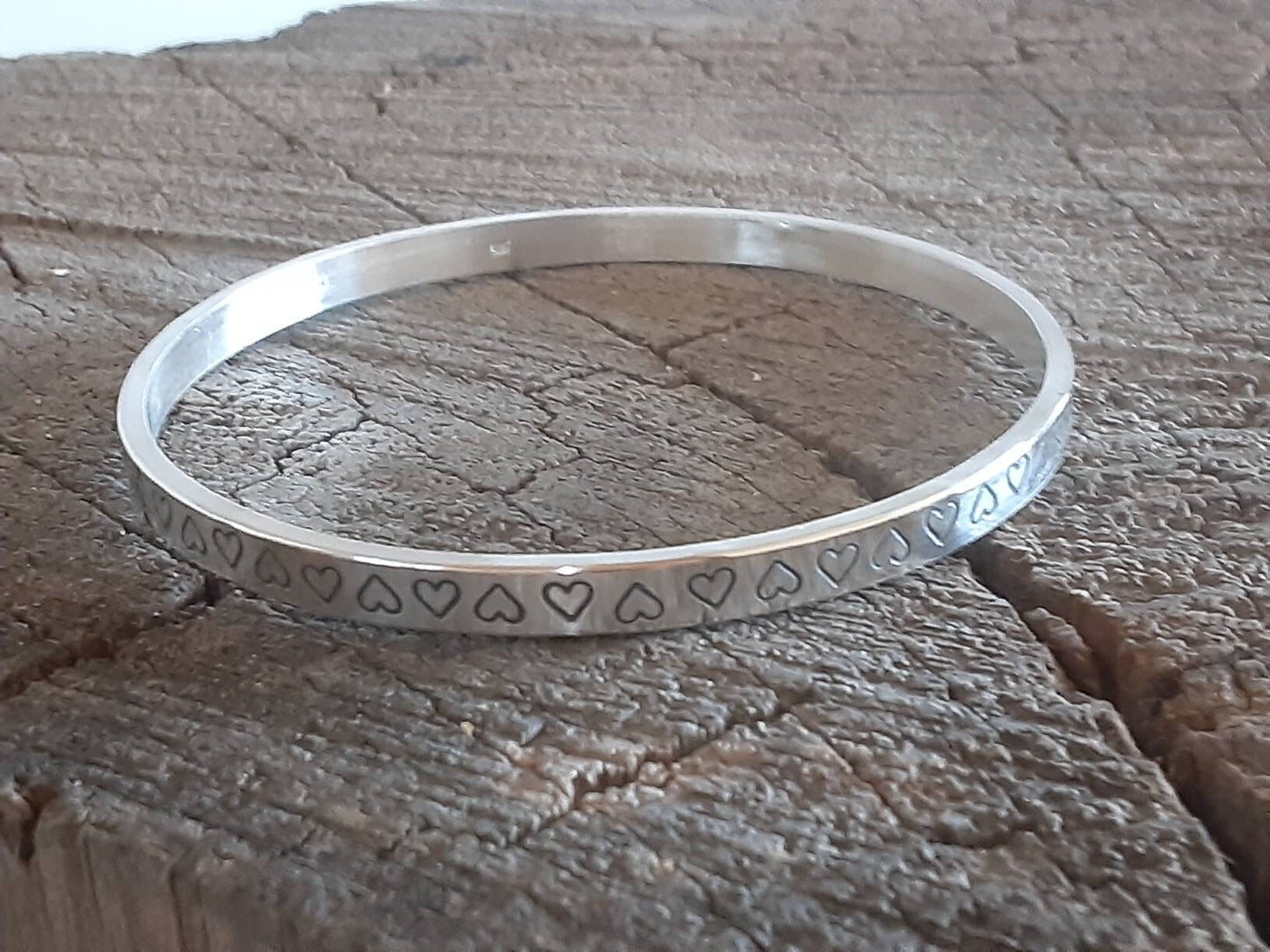 Thick and heavy sterling silver bangle with hearts