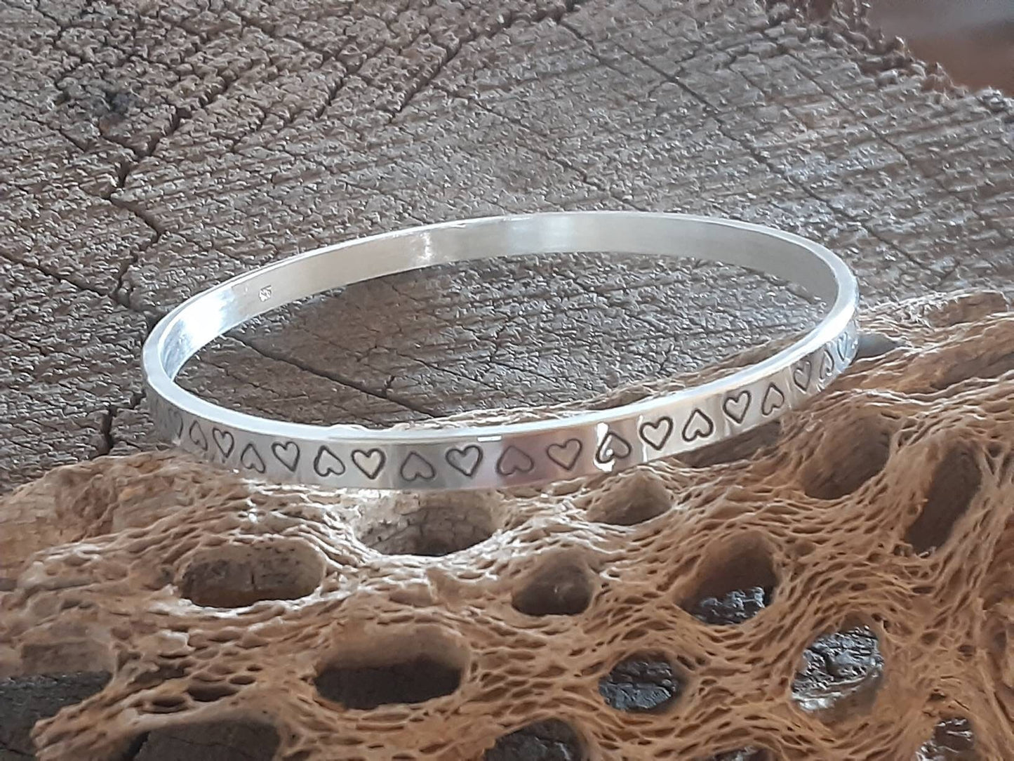 Thick and heavy sterling silver bangle with hearts