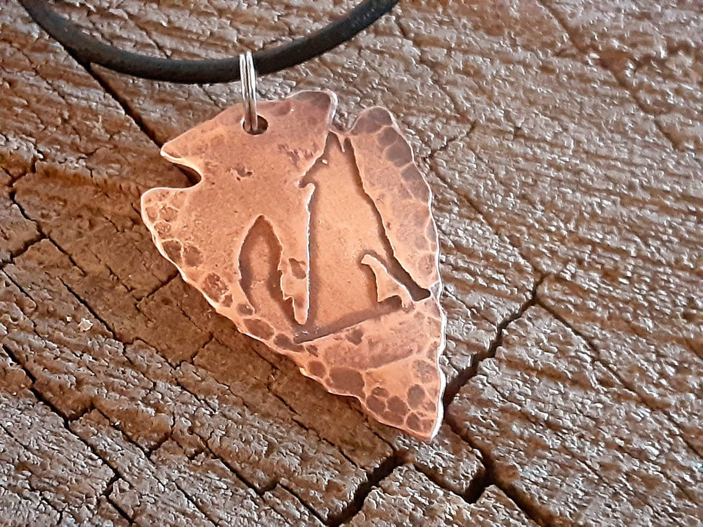 Men's copper arrowhead necklace with howling coyote and an adjustable leather cord