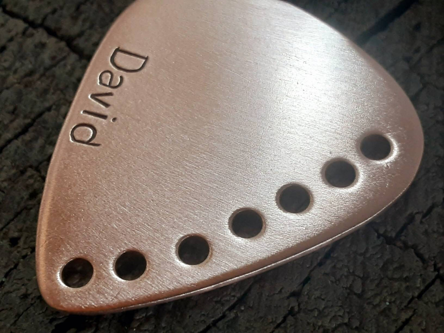 Custom copper guitar pick with holes along the edge and your name