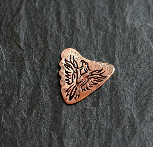 Shark tooth copper guitar pick with a Phoenix