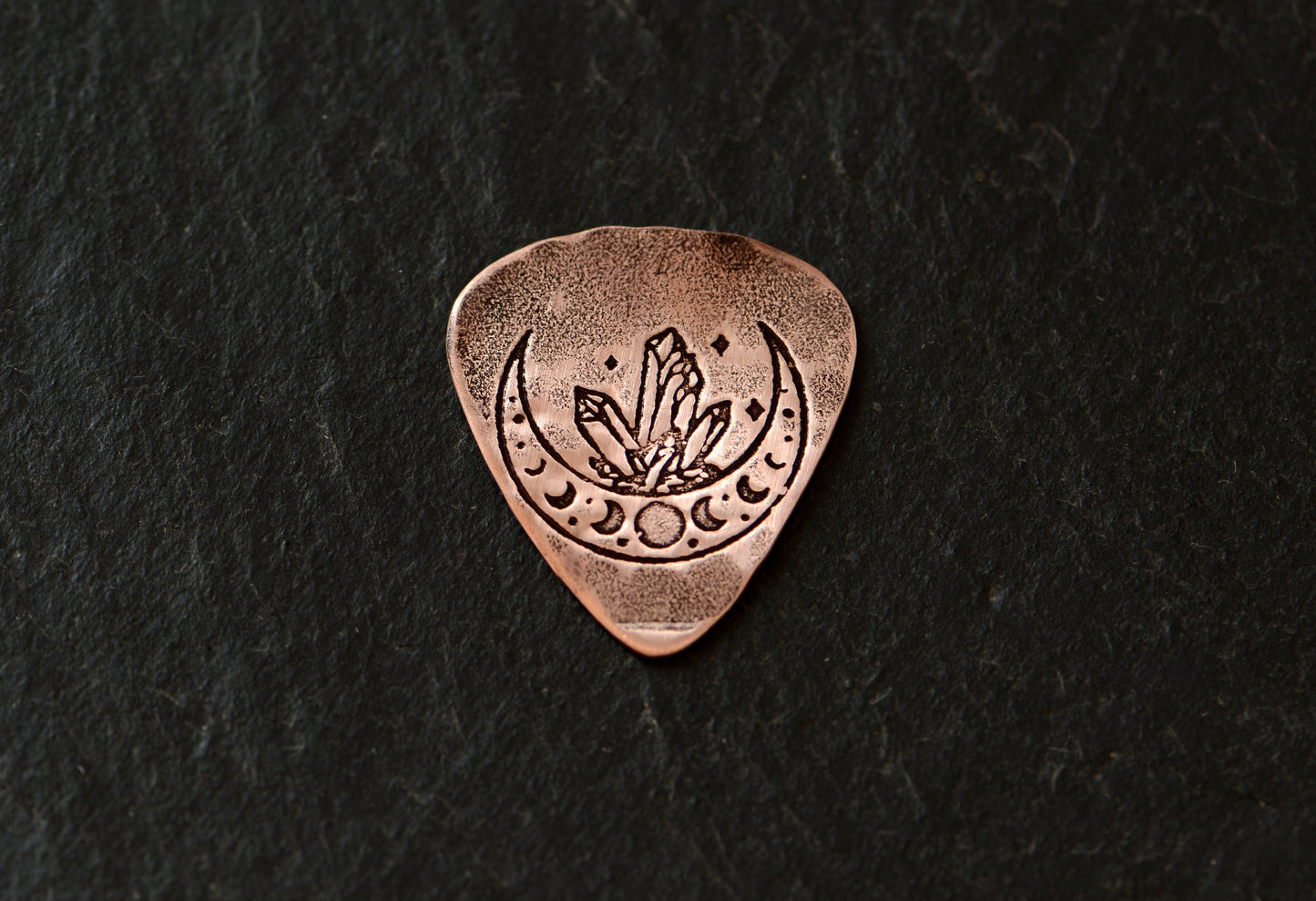 Copper guitar pick with crystal moon