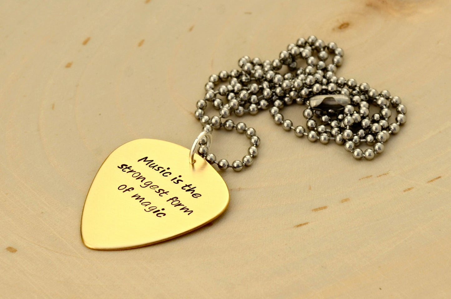 Bronze guitar pick necklace to engrave